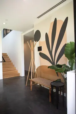 a living room with a bench and a plant at Haven Coliving in Los Angeles