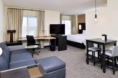 a hotel room with a couch and a bed at Residence Inn by Marriott Bakersfield West in Bakersfield