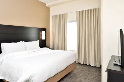 a hotel room with a bed and a television at Residence Inn by Marriott Bakersfield West in Bakersfield