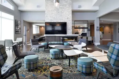 a hotel lobby with chairs and a fireplace at Residence Inn by Marriott Bakersfield West in Bakersfield