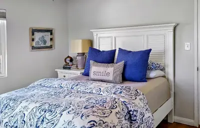 a bedroom with a bed with blue and white pillows at Top Location Walk to Dining, Shops & Near Beach CC E in Culver City