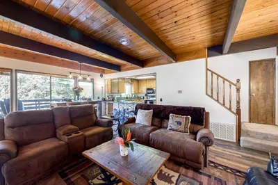 a living room with two couches and a table at House of the Rising Sun in Lake Arrowhead