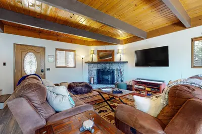 a living room with two couches and a fireplace at House of the Rising Sun in Lake Arrowhead