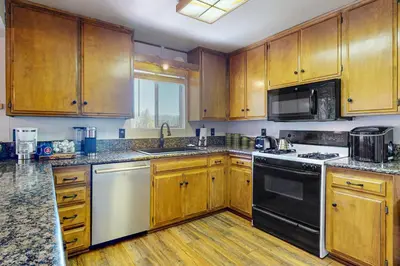 a kitchen with wooden cabinets and a stove top oven at House of the Rising Sun in Lake Arrowhead