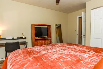 a bedroom with a bed and a flat screen tv at Bohemia Big Bear-1926 by Big Bear Vacations in Big Bear Lake