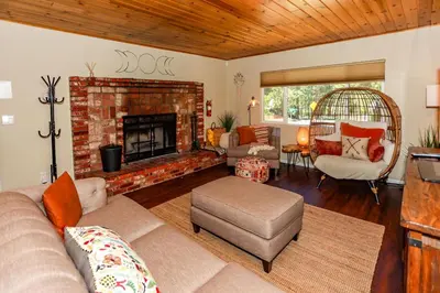 a living room with a couch and a fireplace at Bohemia Big Bear-1926 by Big Bear Vacations in Big Bear Lake