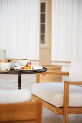 a table with a plate of food on a table at Cara Hotel in Los Angeles