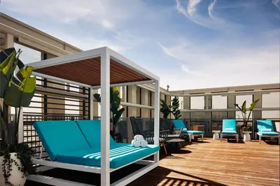 a patio with blue chairs on a deck at Hyatt Place LAX/Century BLVD in Los Angeles