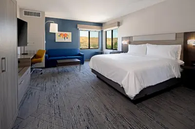 a bedroom with a large bed and a blue wall at Holiday Inn Express & Suites - Valencia - Santa Clarita by IHG in Valencia