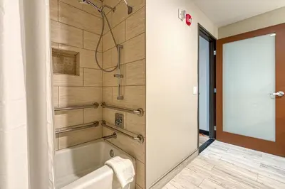 a bathroom with a tub and a shower stall at Hotel Lexen Newhall & Santa Clarita - Near Six Flags Magic Mountain in Santa Clarita