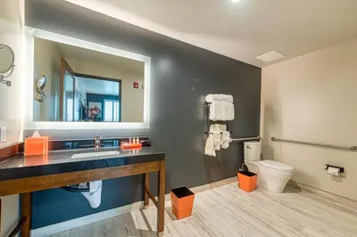 a bathroom with a sink and a toilet and a mirror at Hotel Lexen Newhall & Santa Clarita - Near Six Flags Magic Mountain in Santa Clarita