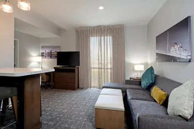 a living room with a couch and a desk at Staybridge Suites - Long Beach Airport by IHG in Long Beach