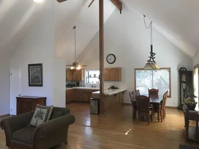 a living room and kitchen with a table and chairs at Quail Run Cabin 4,000 Sq.Ft Largest & Most Beautiful House On The Mountain in Pine Mountain Club