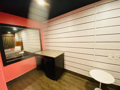 a small room with a desk and a mirror at Casa Valentine Inn - Los Angeles in Los Angeles