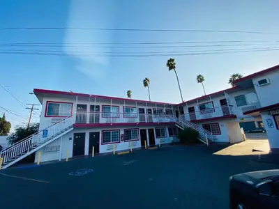 an empty parking lot in front of a building at Casa Valentine Inn - Los Angeles in Los Angeles
