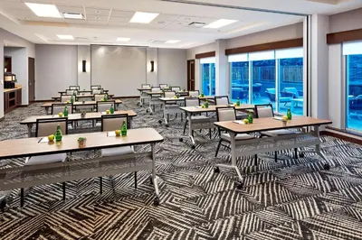 a classroom with tables and chairs in a room with windows at Hyatt Place Los Angeles / LAX / El Segundo in El Segundo