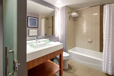 a bathroom with a sink and a toilet and a tub at Hyatt Place Los Angeles / LAX / El Segundo in El Segundo