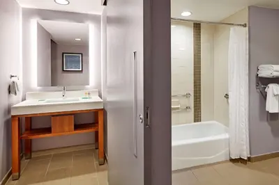 a bathroom with a sink and a bath tub at Hyatt Place Los Angeles / LAX / El Segundo in El Segundo