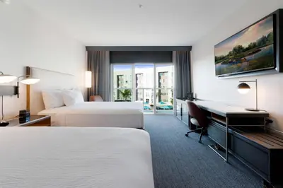 a hotel room with two beds and a desk at Courtyard by Marriott Marina del Rey in Los Angeles