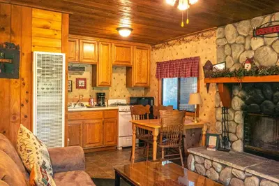 a kitchen and living room with a table and a fireplace at Eagle's Nest in Big Bear Lake