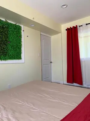 a bedroom with a bed and a red curtain at LAX guest house in Inglewood