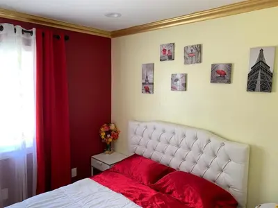 a bedroom with a white bed with a red blanket at LAX guest house in Inglewood