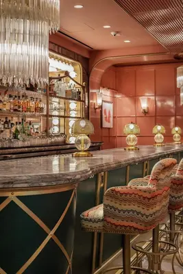 a bar with chairs and a counter in a room at The Sun Rose West Hollywood in Los Angeles