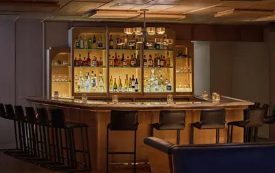 a bar with a lot of bottles of alcohol at The Sun Rose West Hollywood in Los Angeles