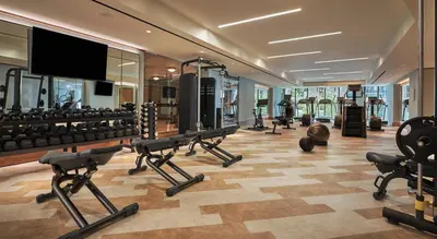 a fitness room with a gym with tread machines at The Sun Rose West Hollywood in Los Angeles