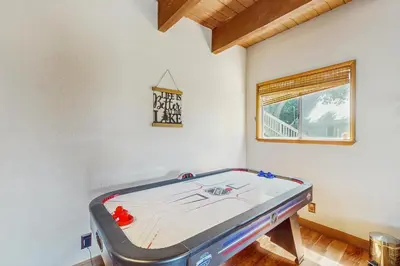a room with a ping pong table in it at Lake View Magic in Crestline