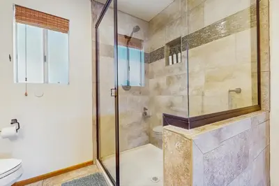 a bathroom with a shower and a toilet at Lake View Magic in Crestline