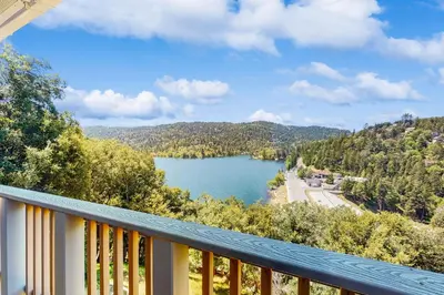 a view of a lake from a balcony at Lake View Magic in Crestline