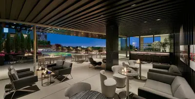 a lobby with chairs and tables and a pool at AKA West Hollywood in Los Angeles