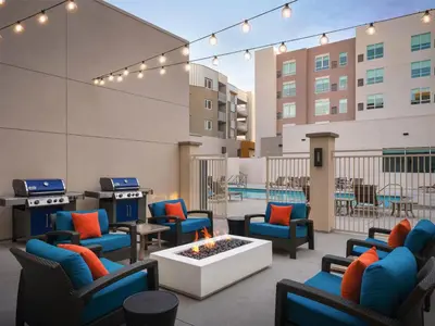an outdoor patio with chairs and a fire pit at Hyatt House LA - University Medical Center in Los Angeles