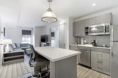 a kitchen with a island in the middle of a room at Hyatt House LA - University Medical Center in Los Angeles