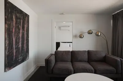 a living room with a couch and a large painting at Hollywood Hills Hotel in Los Angeles