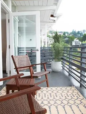 a porch with two chairs and a table and a plant at Hollywood Hills Hotel in Los Angeles