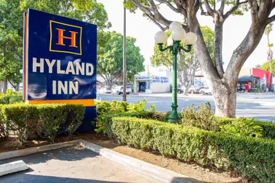 a sign for hyannis island inn next to a street light at Hyland Inn near Pasadena Civic Center in Pasadena