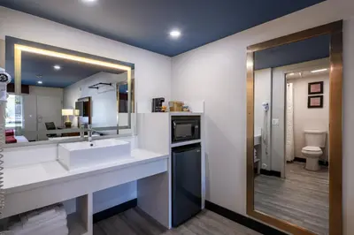 a bathroom with a sink and a mirror at Hyland Inn near Pasadena Civic Center in Pasadena