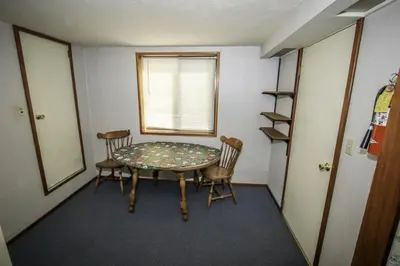 a room with a table and chairs and a window at A Big Olympic Getaway apts in Big Bear Lake