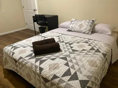 a bedroom with a bed with a quilt on it at Casa Tranquila in Santa Ana