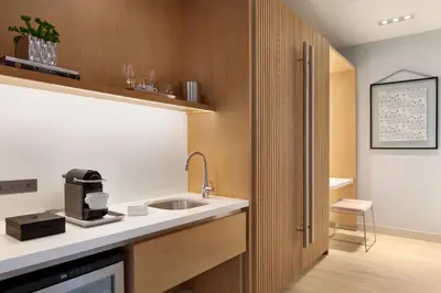 a kitchen with a sink and a microwave at The Viv Hotel, Anaheim, a Tribute Portfolio Hotel in Anaheim