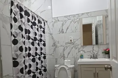 a bathroom with a toilet and a sink and a mirror at Los Angeles Retreat Close to Hotspots in Los Angeles