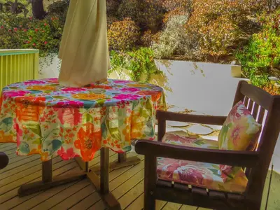 a table and two chairs on a deck at Topanga Canyon Inn Bed and Breakfast in Topanga