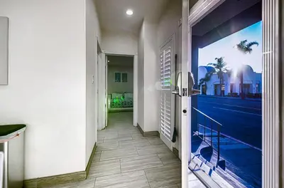 a hallway with a door with a view of the ocean at Stylish Modern Home, AC, Parking & Near FWYs in Santa Ana