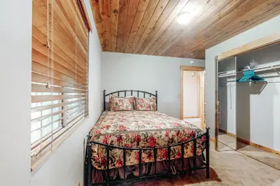 a bedroom with a bed and a window at Sky High Cabin in Crestline
