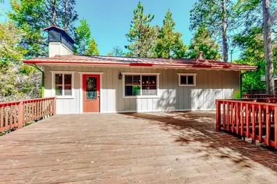a small house with a red fence in front of it at Sky High Cabin in Crestline