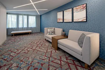 a living room with two chairs and a table at SpringHill Suites by Marriott Valencia in Valencia