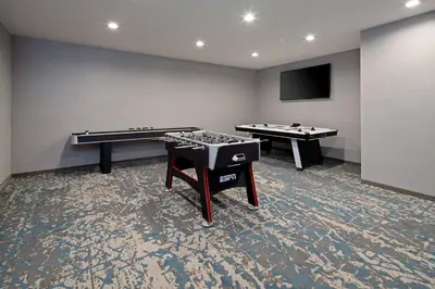 a room with two ping pong tables and a flat screen tv at Residence Inn by Marriott Valencia in Valencia