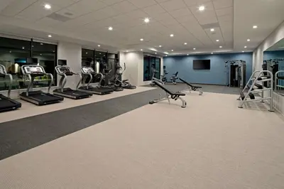 a gym with treadmills and ellipticals in a building at Residence Inn by Marriott Valencia in Valencia